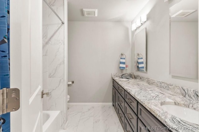 bathroom featuring baseboards, marble finish floor, toilet, a sink, and double vanity