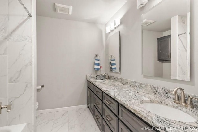 bathroom featuring a sink, double vanity, baseboards, and visible vents