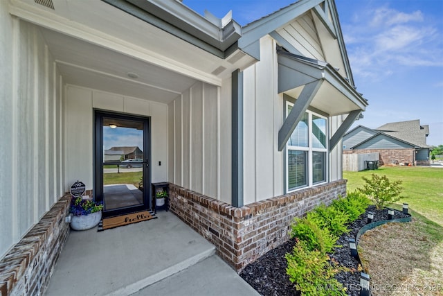 3494 E 155th St S, Bixby, OK 74008 - doorway to property with brick siding, board and batten siding, and a yard