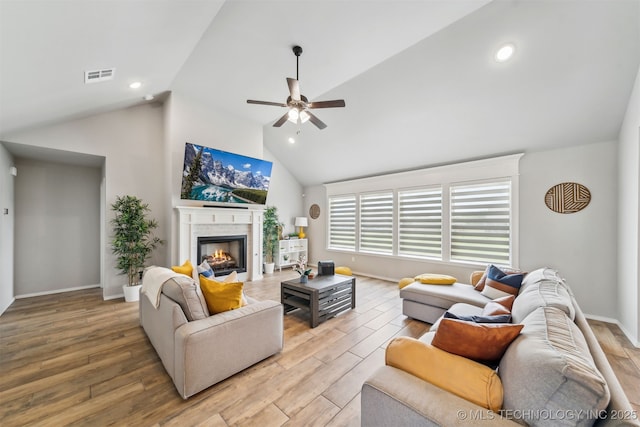 3494 E 155th St S, Bixby, OK 74008 - living room with a ceiling fan, a lit fireplace, light wood finished floors, baseboards, and high vaulted ceiling