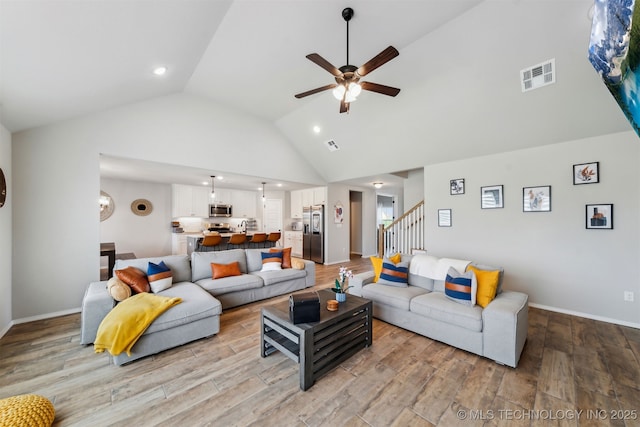 3494 E 155th St S, Bixby, OK 74008 - living room with a ceiling fan, stairs, light wood-style flooring, high vaulted ceiling, and recessed lighting