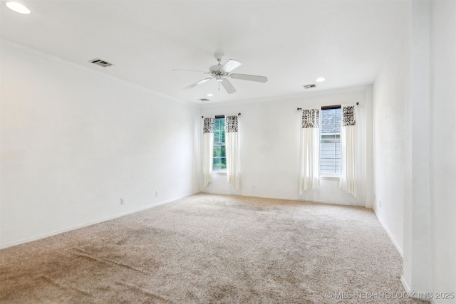 spare room featuring ornamental molding, carpet, a ceiling fan, baseboards, and recessed lighting