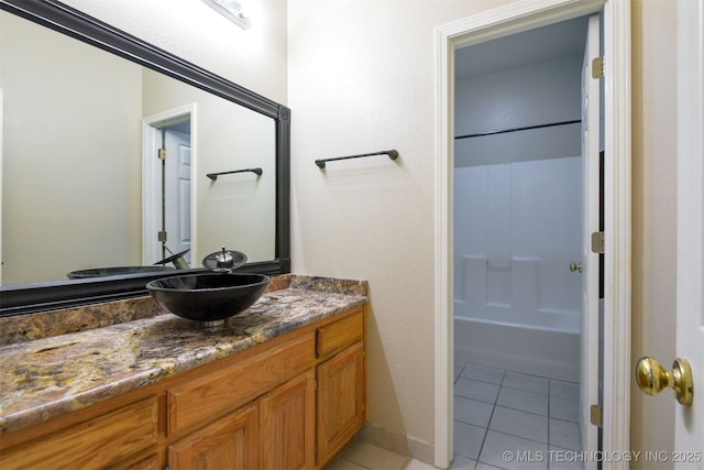 full bath with tile patterned floors, vanity, and bathing tub / shower combination