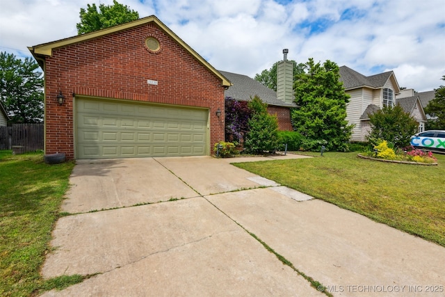 traditional home featuring brick siding, a chimney, a front yard, and concrete driveway