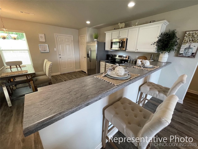 8327 E Queens St, Broken Arrow, OK 74014 - kitchen with recessed lighting, baseboards, stainless steel appliances, white cabinets, and dark wood-style floors