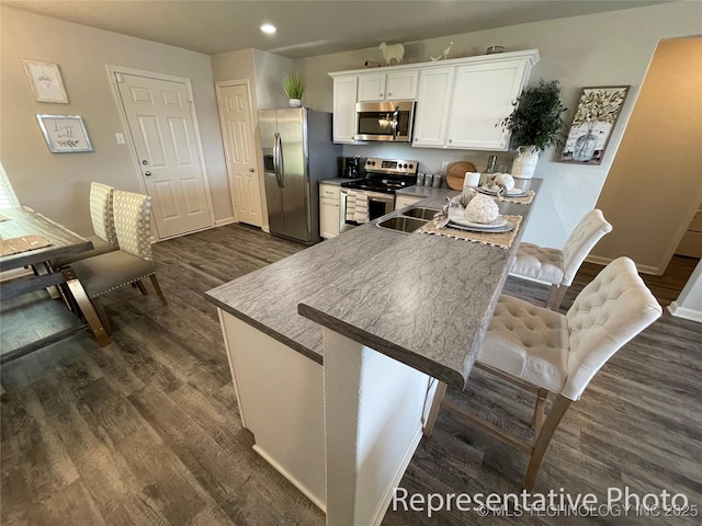 8327 E Queens St, Broken Arrow, OK 74014 - kitchen featuring stainless steel appliances, dark wood finished floors, white cabinetry, baseboards, and recessed lighting