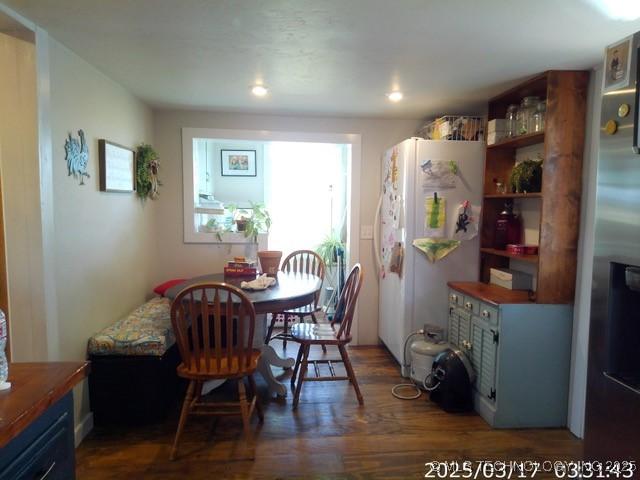 dining space with wood finished floors