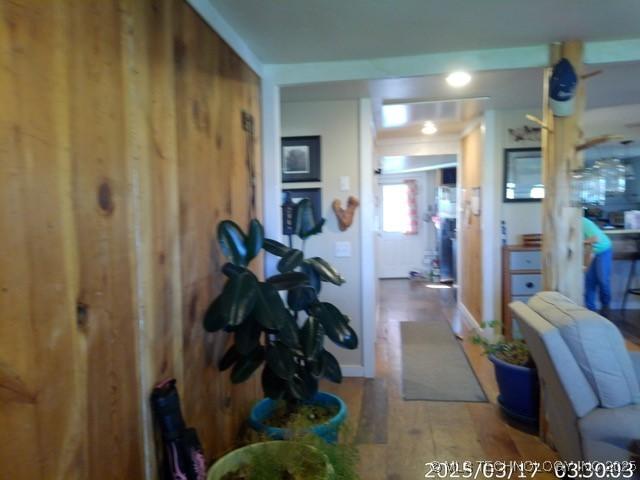 hallway with hardwood / wood-style flooring