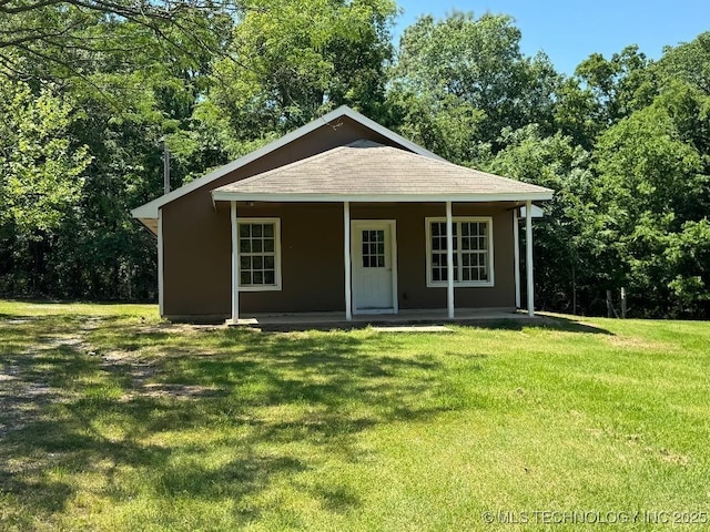 bungalow-style home featuring a porch, a shingled roof, and a front lawn