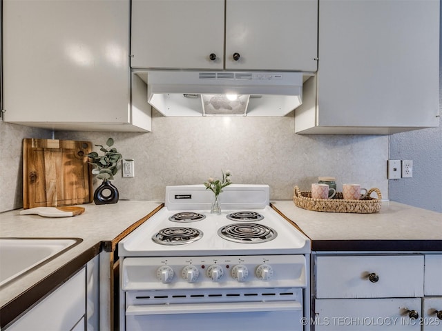kitchen with under cabinet range hood, backsplash, light countertops, and white range with electric cooktop
