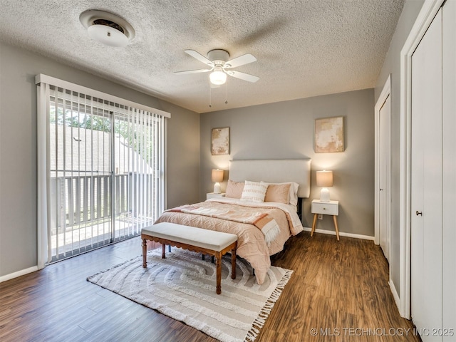 bedroom featuring baseboards, access to outside, and wood finished floors