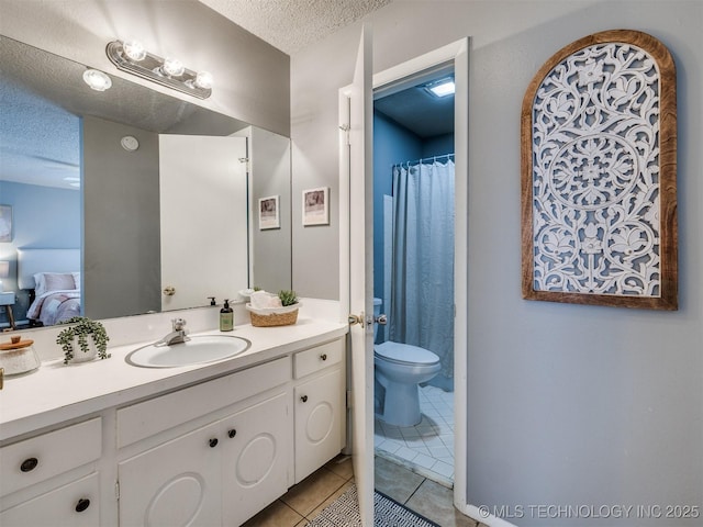 ensuite bathroom featuring a textured ceiling, toilet, ensuite bath, tile patterned flooring, and vanity
