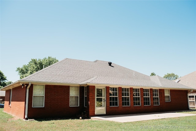 3926 W 15th Ave, Stillwater, OK 74074 - back of house with a patio area, brick siding, roof with shingles, and a yard