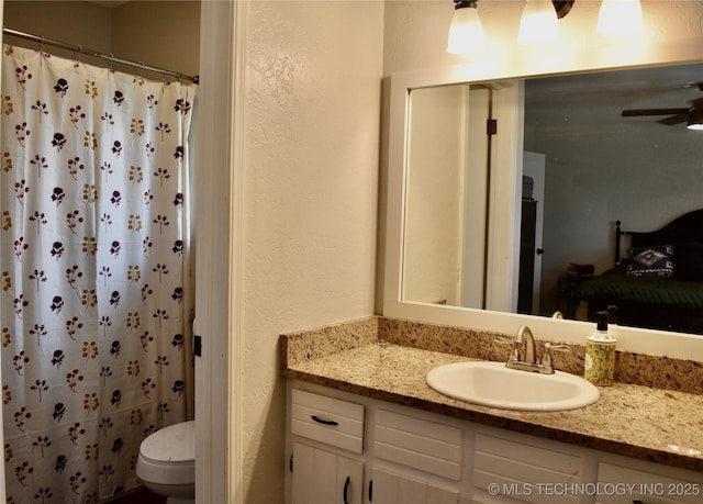 606 Rosewood Ct, Claremore, OK 74017 - ensuite bathroom featuring a textured wall, vanity, toilet, a shower with shower curtain, and ceiling fan