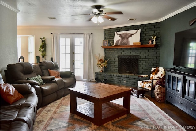 606 Rosewood Ct, Claremore, OK 74017 - living room with ceiling fan, ornamental molding, a brick fireplace, and wood finished floors