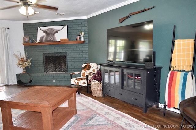 606 Rosewood Ct, Claremore, OK 74017 - living room featuring crown molding, wood finished floors, ceiling fan, and a fireplace