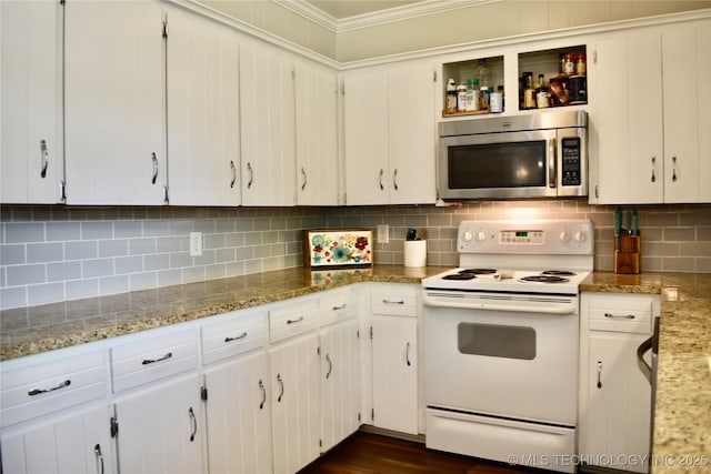 606 Rosewood Ct, Claremore, OK 74017 - kitchen featuring stainless steel microwave, electric range, crown molding, tasteful backsplash, and white cabinets