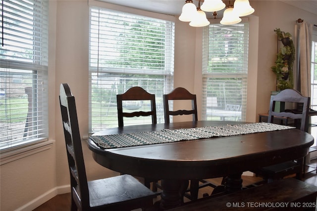 606 Rosewood Ct, Claremore, OK 74017 - dining area featuring a chandelier, baseboards, and plenty of natural light