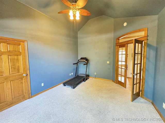 workout area featuring a ceiling fan, french doors, baseboards, carpet flooring, and vaulted ceiling