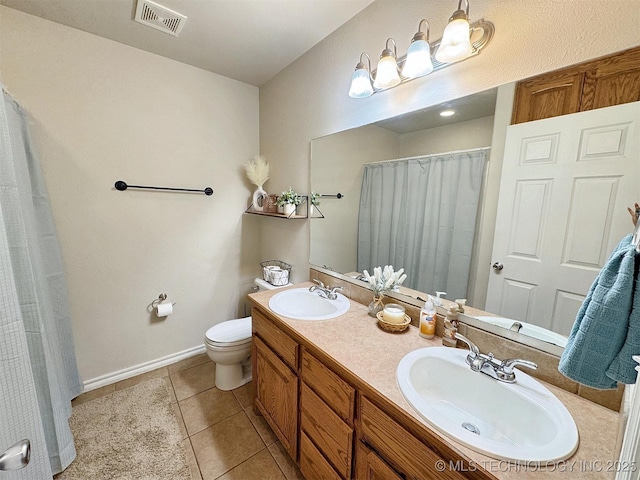 bathroom with toilet, tile patterned flooring, visible vents, and a sink