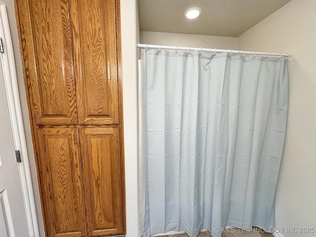 bathroom with a shower with curtain and recessed lighting