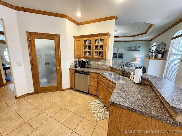 kitchen with light tile patterned floors, a sink, dark countertops, crown molding, and dishwasher