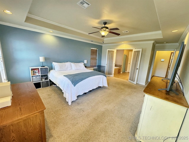 bedroom featuring ornamental molding, a raised ceiling, light carpet, and visible vents