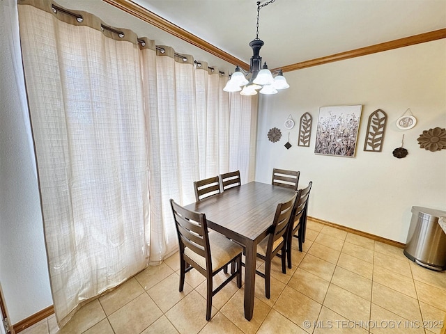 dining area featuring light tile patterned floors, baseboards, an inviting chandelier, and crown molding