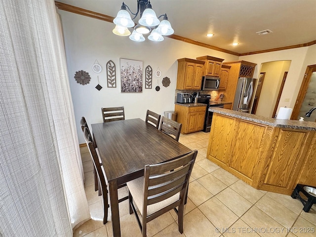 dining room featuring crown molding, light tile patterned floors, visible vents, and a notable chandelier