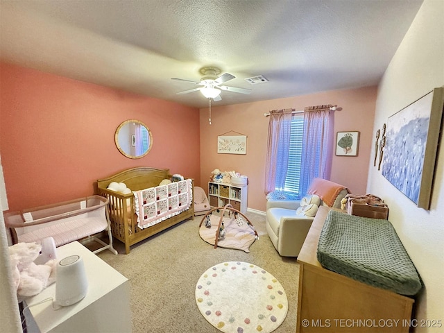 bedroom featuring a ceiling fan, visible vents, and carpet