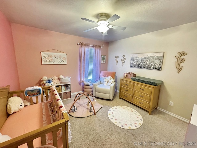 bedroom with light carpet, baseboards, and a ceiling fan