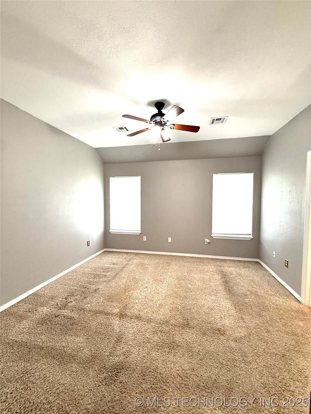 unfurnished room with a ceiling fan, carpet floors, and baseboards