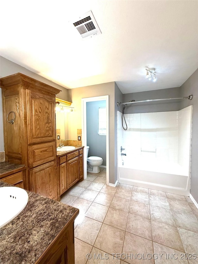 bathroom with toilet, tub / shower combination, vanity, baseboards, and tile patterned flooring