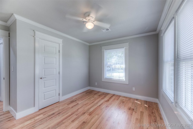 interior space featuring baseboards, ceiling fan, light wood-style flooring, and visible vents