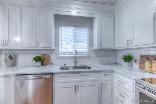 kitchen with a sink, light stone counters, backsplash, white cabinets, and stainless steel dishwasher