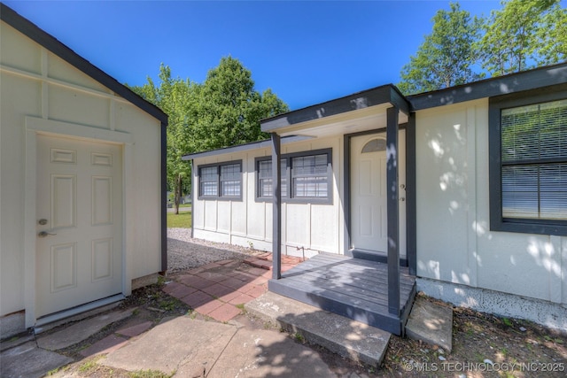 doorway to property featuring board and batten siding