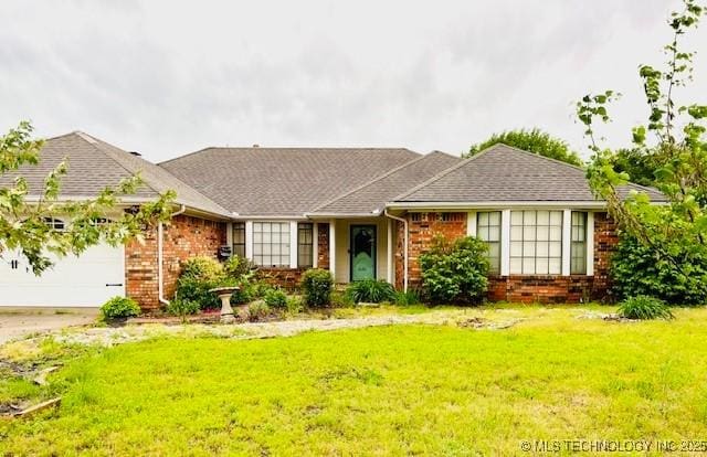 ranch-style house featuring a garage, a front lawn, brick siding, and driveway