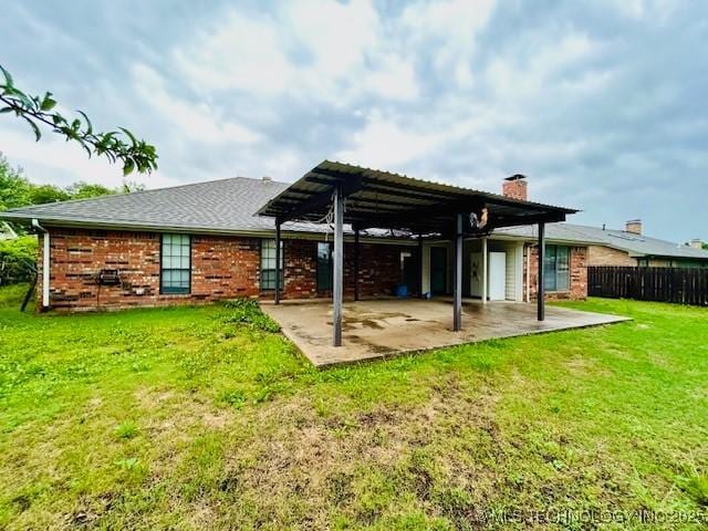 back of property with a lawn, a chimney, fence, a patio area, and a pergola