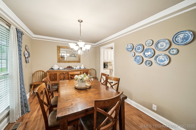 4721 S Irvington Pl, Tulsa, OK 74135 - dining space with wood finished floors, a chandelier, and crown molding