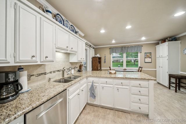 4721 S Irvington Pl, Tulsa, OK 74135 - kitchen with dishwasher, a peninsula, crown molding, white cabinets, and decorative backsplash