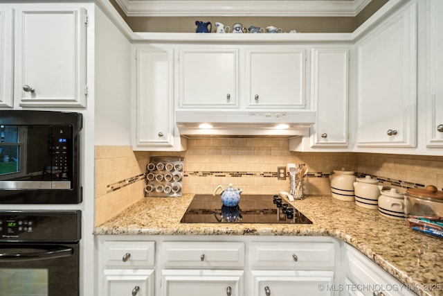 4721 S Irvington Pl, Tulsa, OK 74135 - kitchen with black appliances, under cabinet range hood, white cabinets, ornamental molding, and decorative backsplash
