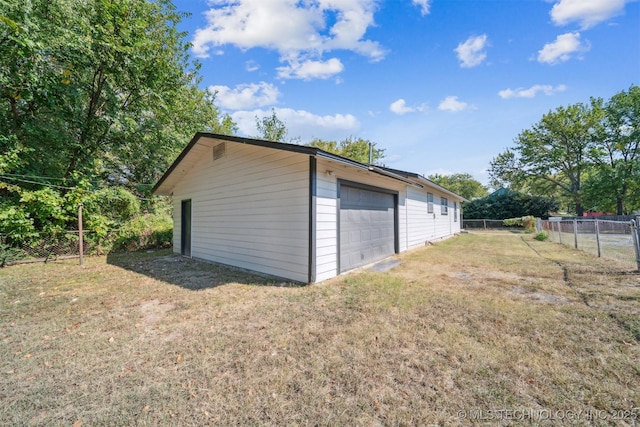 detached garage featuring fence