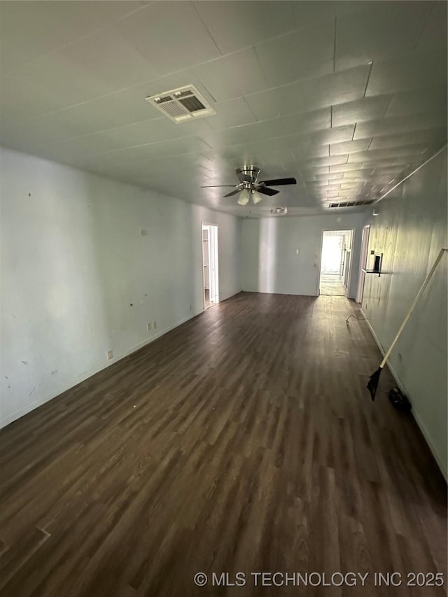 417 E SE, Ardmore, OK 73401 - unfurnished room with dark wood-style flooring, ceiling fan, and baseboards