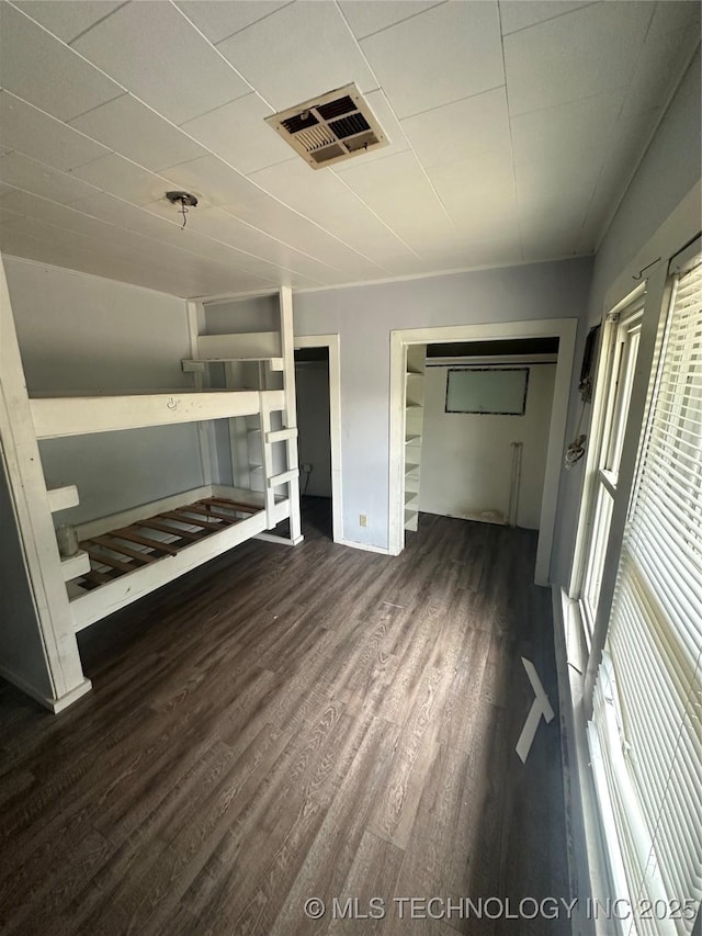 417 E SE, Ardmore, OK 73401 - unfurnished bedroom featuring dark wood finished floors