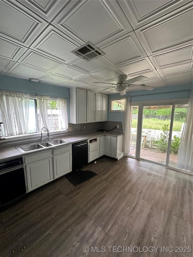 417 E SE, Ardmore, OK 73401 - kitchen with a sink, black dishwasher, an ornate ceiling, white cabinets, and light countertops