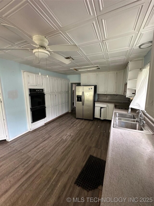 417 E SE, Ardmore, OK 73401 - kitchen with stainless steel fridge, a sink, dark wood-style flooring, an ornate ceiling, and ceiling fan