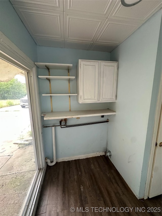 417 E SE, Ardmore, OK 73401 - laundry room featuring dark wood finished floors and baseboards