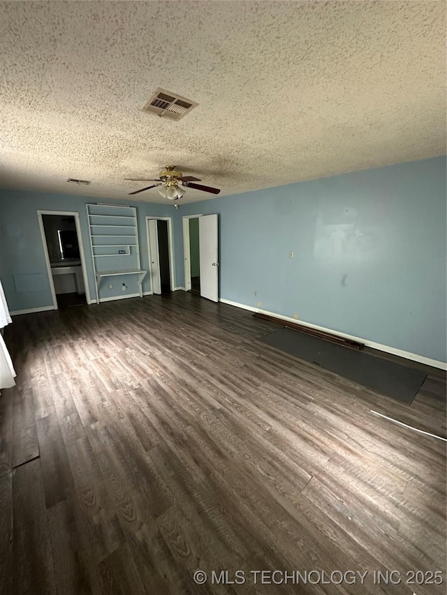 417 E SE, Ardmore, OK 73401 - unfurnished bedroom featuring a textured ceiling, dark wood finished floors, baseboards, and a ceiling fan