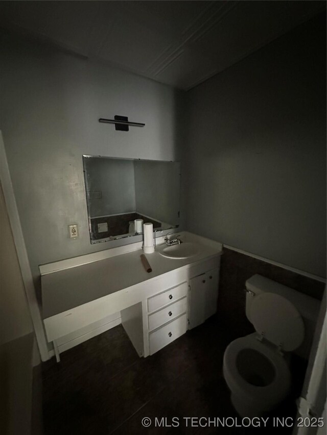 417 E SE, Ardmore, OK 73401 - bathroom with vanity, toilet, and tile patterned flooring