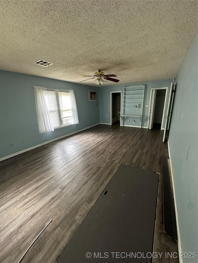 417 E SE, Ardmore, OK 73401 - spare room with a ceiling fan, a textured ceiling, dark wood-style flooring, and baseboards